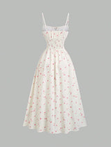 Robe longue fleurie à fines bretelles et nœud à la taille