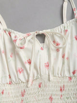 Robe longue fleurie à fines bretelles et nœud à la taille