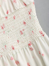 Robe longue fleurie à fines bretelles et nœud à la taille