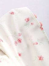 Robe longue fleurie à fines bretelles et nœud à la taille