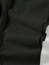 Jupe noire mi-longue fendue à volants plissés