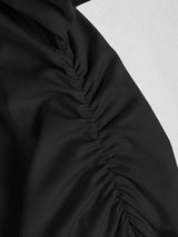 Jupe noire mi-longue fendue à volants plissés