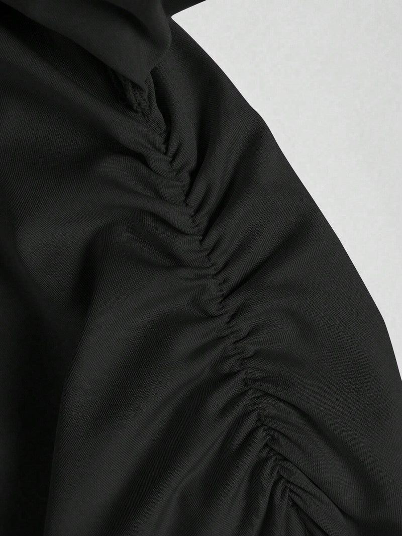 Jupe noire mi-longue fendue à volants plissés