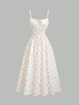 Robe longue fleurie à fines bretelles et nœud à la taille